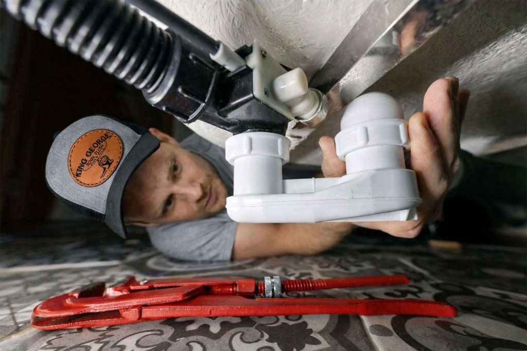 emergency-plumber-fixing-under-sink-leak-2